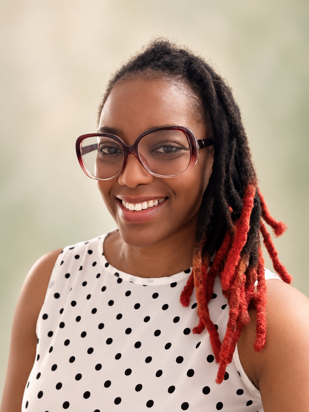 Dr. Lucy Evans smiling in a black-and-white polka-dot top